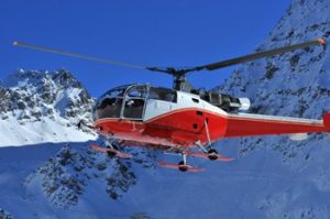 helicopter crash attorney flying near snow covered mountains
